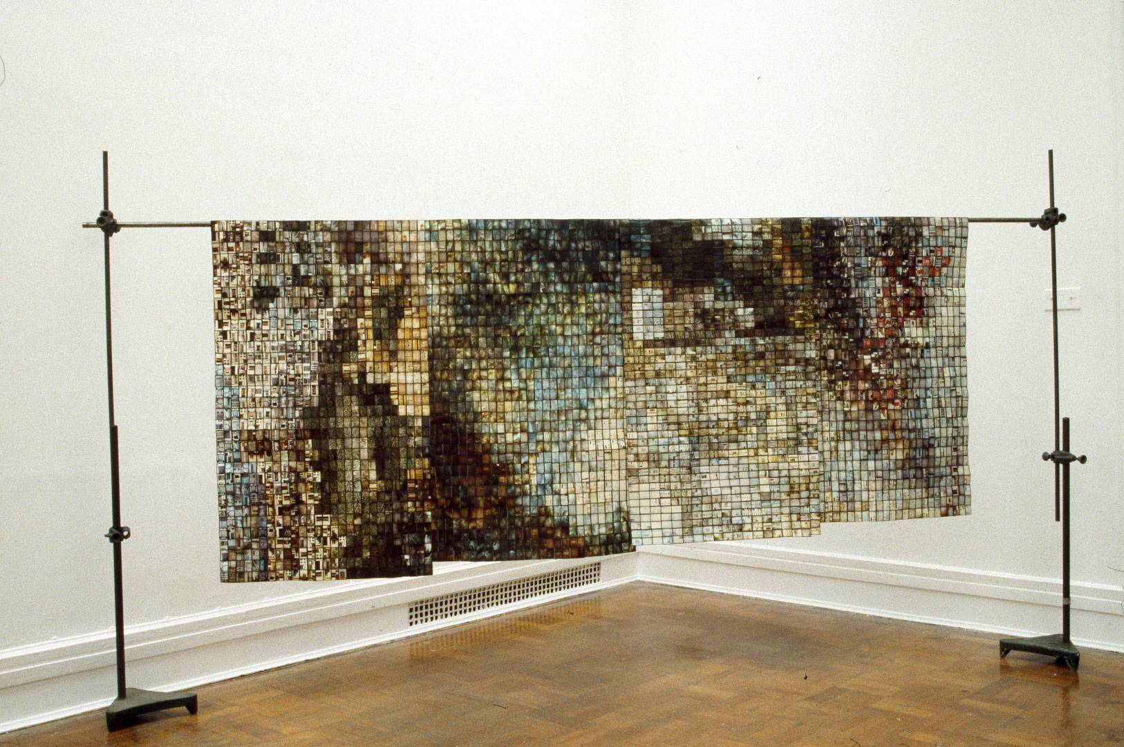 installation view of an art work made of hundreds of individual photographs threaded together