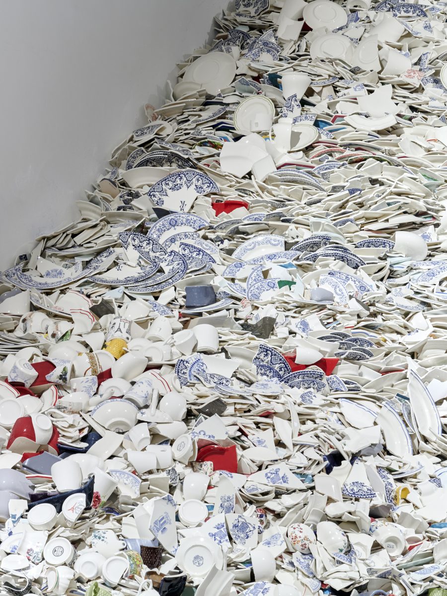 photograph of a sculpture made of broken plates and other ceramic items