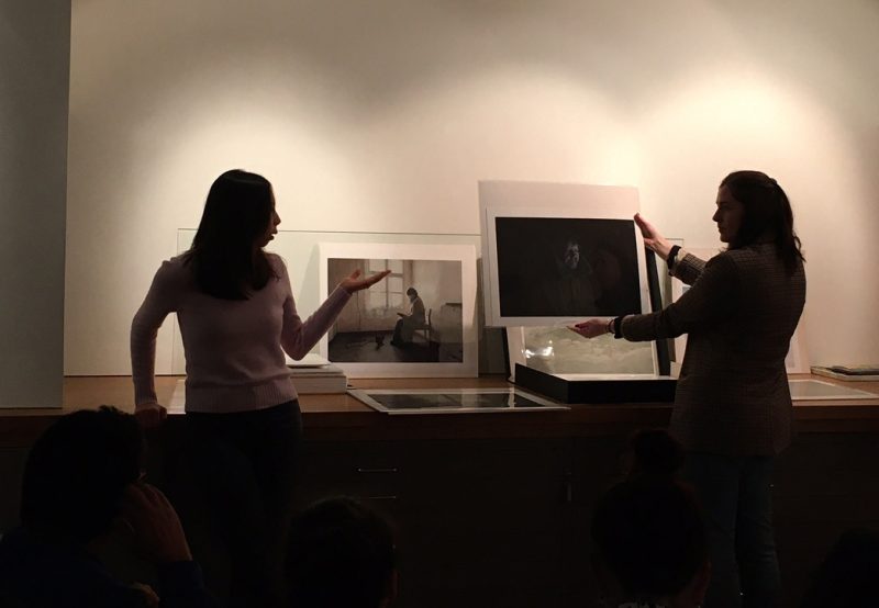 Photograph of people holding up photographic prints, taking at the photographer's gallery (TPG) in London 2023