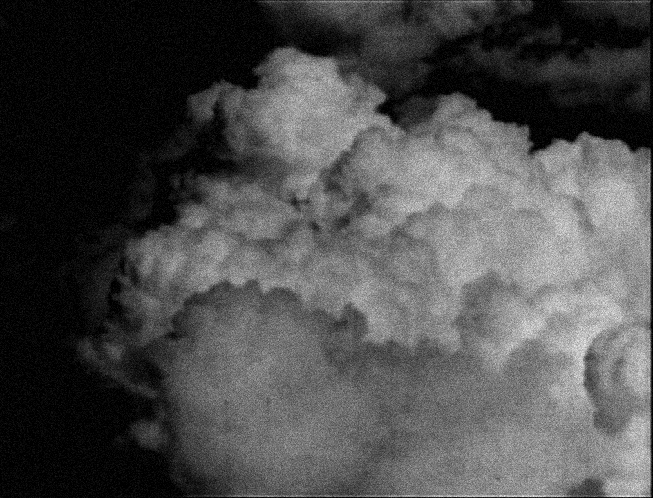 black and white film still of a fluffy cloud