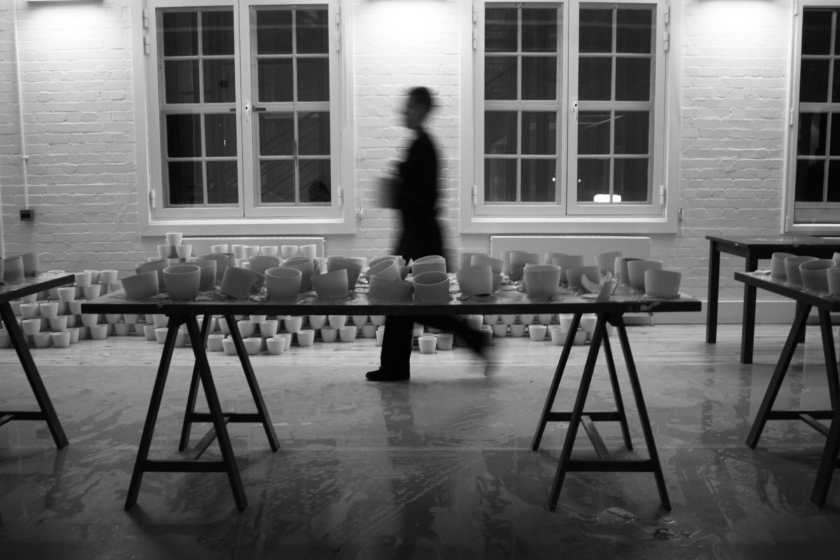 photograph with clare twomey in a studio with ceramics on a table